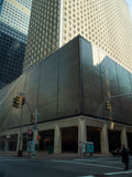 Fine art photograph of a mid-century modern concrete facade in New York City, strong grid structure, repetitive geometry, light and shadow, 1960s architectural aesthetics