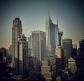 Fine art photograph of Midtown Manhattan skyscrapers forming rhythmic vertical structures, architectural repetition, mid-century modern influence, urban soundscape and visual rhythm