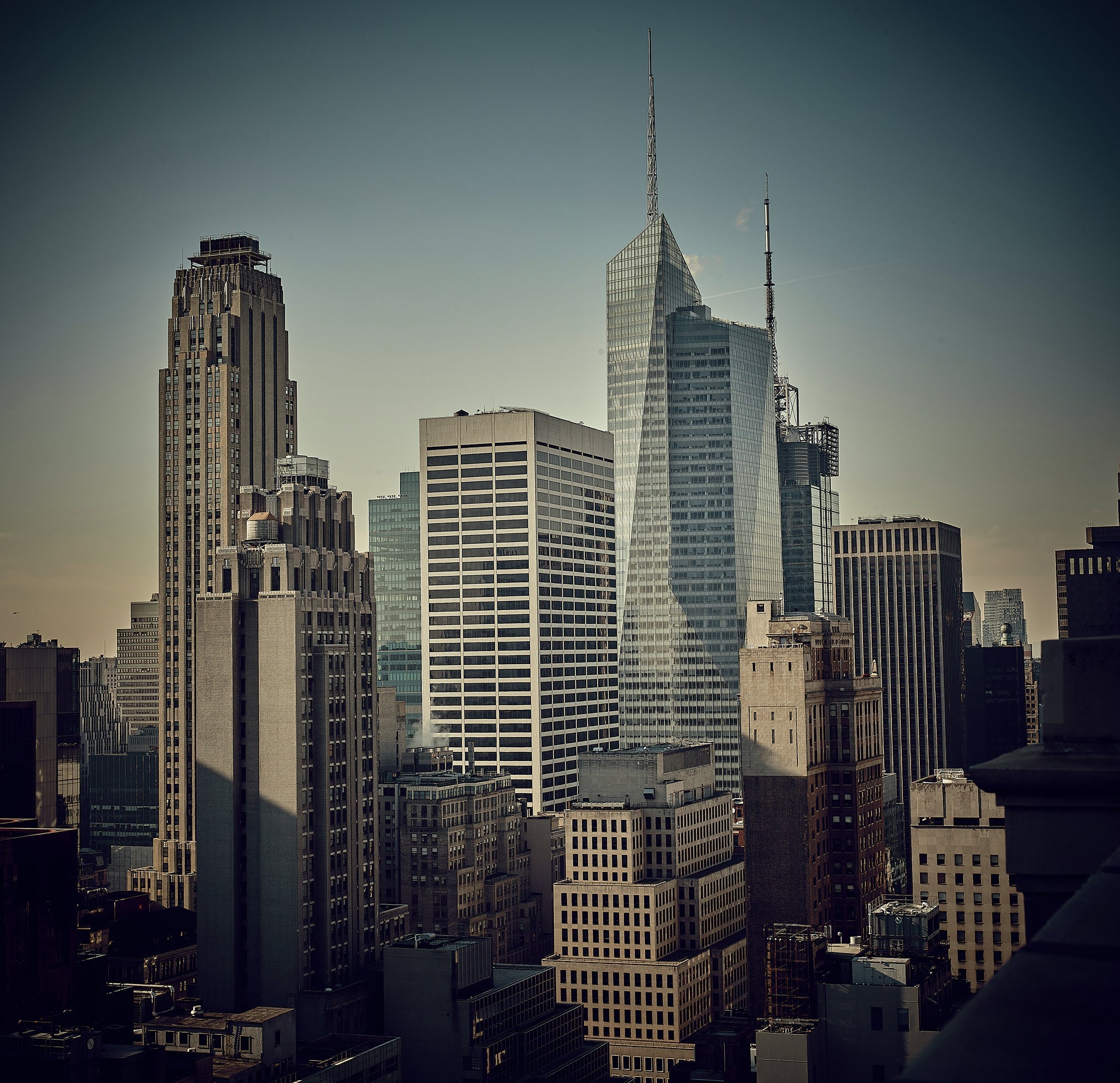 Fine art photograph of Midtown Manhattan skyscrapers forming rhythmic vertical structures, architectural repetition, mid-century modern influence, urban soundscape and visual rhythm
