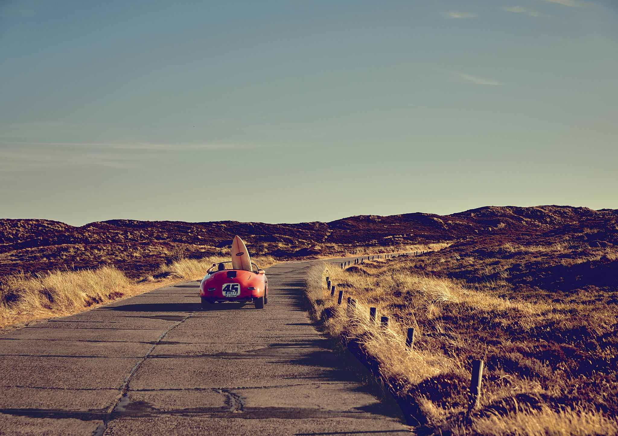 Patinated Porsche 356 Speedster with surfboard on a dune road in Sylt, cinematic summer freedom, coastal fine art photograph